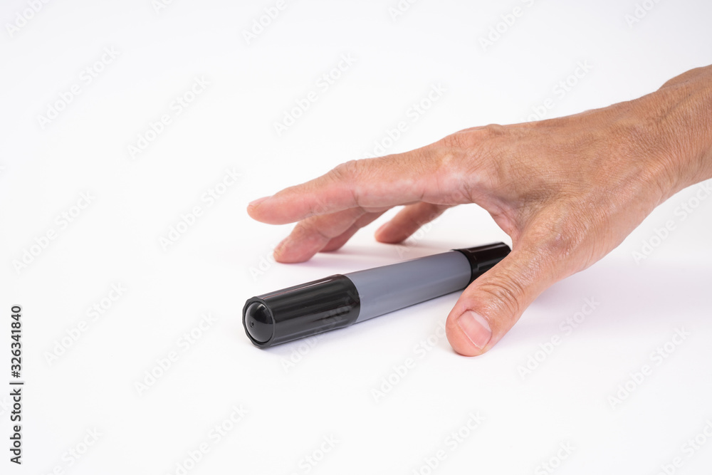 Man hand holding black magic marker pen writing on white background Man hand holding black magic marker pen writing on white background