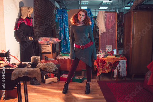 Beautiful curly red-haired girl in the Soviet room.