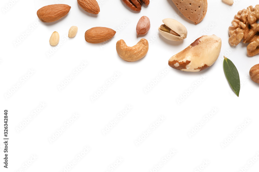 Different delicious nuts on white background, flat lay. Space for text Different delicious nuts on white background, flat lay. Space for text
