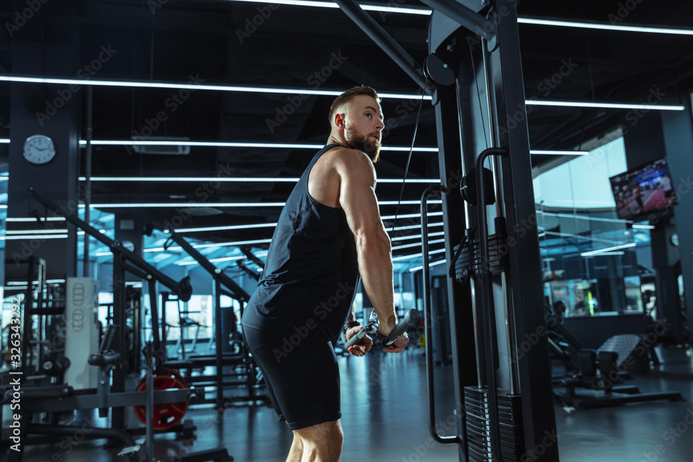 Best choice. Young muscular caucasian athlete training in gym, doing strength exercises, practicing, work on his upper body with weights and barbell. Fitness, wellness, healthy lifestyle concept. Best choice. Young muscular caucasian athlete training in gym, doing strength exercises, practicing, work on his upper body with weights and barbell. Fitness, wellness, healthy lifestyle concept.