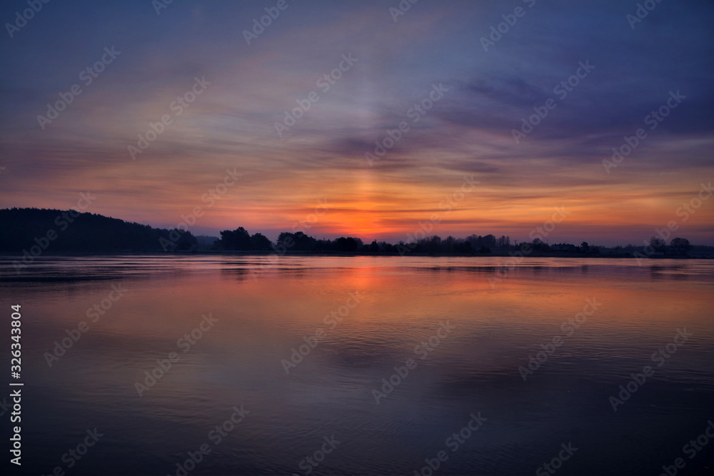 Sun pillar over the Vistula river in northern Poland, just before the sunrise. Sun pillar over the Vistula river in northern Poland, just before the sunrise.