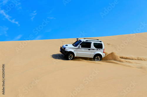An suv was driving through the desert