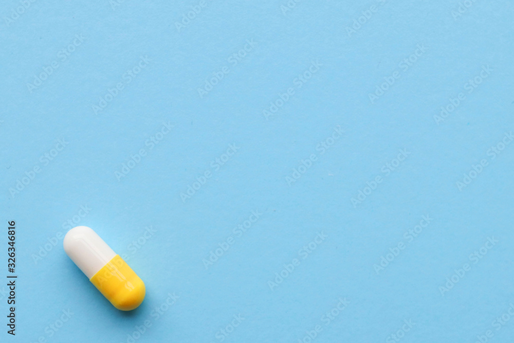 One capsule on a blue background, space for text One capsule on a blue background, space for text