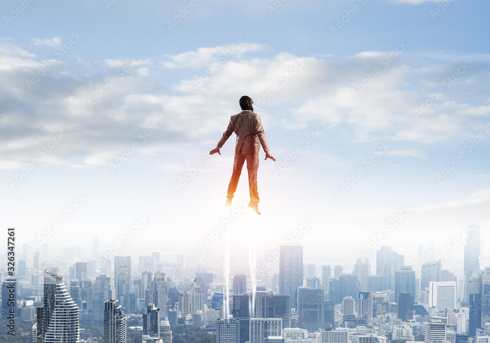 Businessman in suit and aviator hat flying in sky Businessman in suit and aviator hat flying in sky