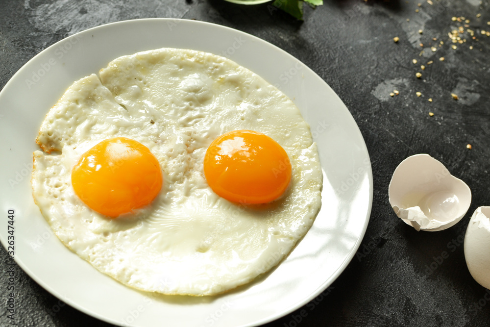 Fried eggs in a plate. Fried eggs close-up. Tasty and healthy breakfast. Yolk close-up. Fried eggs in a plate. Fried eggs close-up. Tasty and healthy breakfast. Yolk close-up.