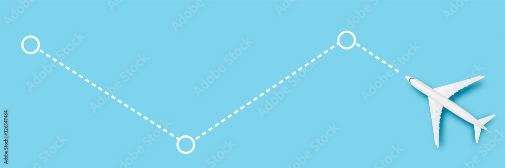 Airplane and line indicating the route on a blue background. Concept travel, airline tickets, flight, route pallet. Banner. Flat lay, top view