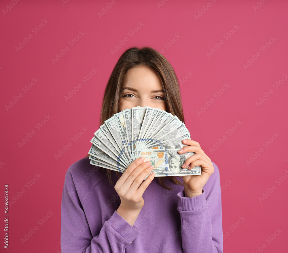 Young woman with cash money on pink background. Space for text Young woman with cash money on pink background. Space for text