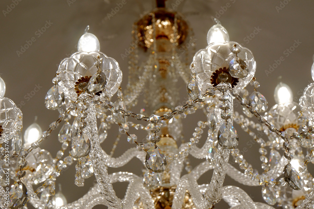 Luxury chandelier on the ceiling of a luxury restaurant. Close-up. Selective focus.