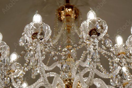 Luxury chandelier on the ceiling of a luxury restaurant. Close-up. Selective focus.