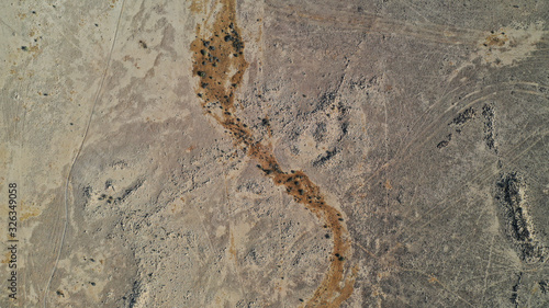 Aerial top down view of Negev desert, Ezuz village. Sandy land surface from above. Beautiful patterns on earth. Texture, background. Israel. © dimabucci