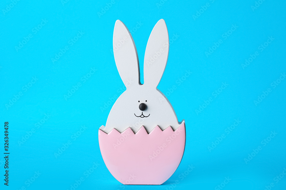 Bunny figure as Easter decor on blue background Bunny figure as Easter decor on blue background
