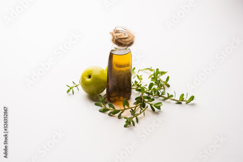 Brahmi Amla Ayurvedic Hair Oil with raw avla and Bramhi leaves photo