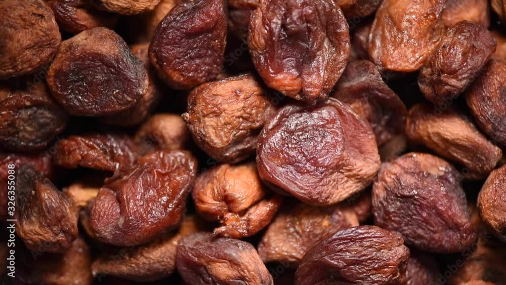 Homemade dried apricots on rotating background. Dried fruits background. Vegan, vegetarian diet. Healthy lifestyle. Fresh sweet apricot texture, organic food. Food ingredient background. Homemade dried apricots on rotating background. Dried fruits background. Vegan, vegetarian diet. Healthy lifestyle. Fresh sweet apricot texture, organic food. Food ingredient background.