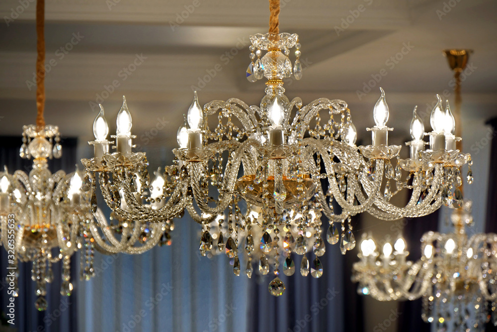 Luxury chandelier on the ceiling of a luxury restaurant.  Selective focus.