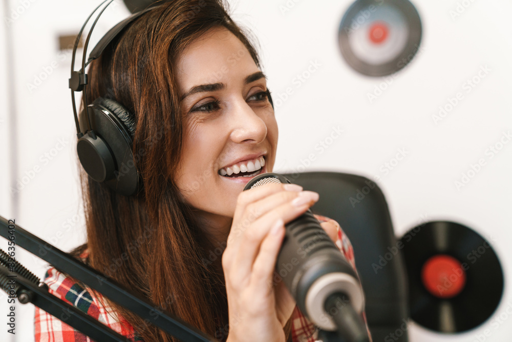 Smiling young woman radio host Smiling young woman radio host