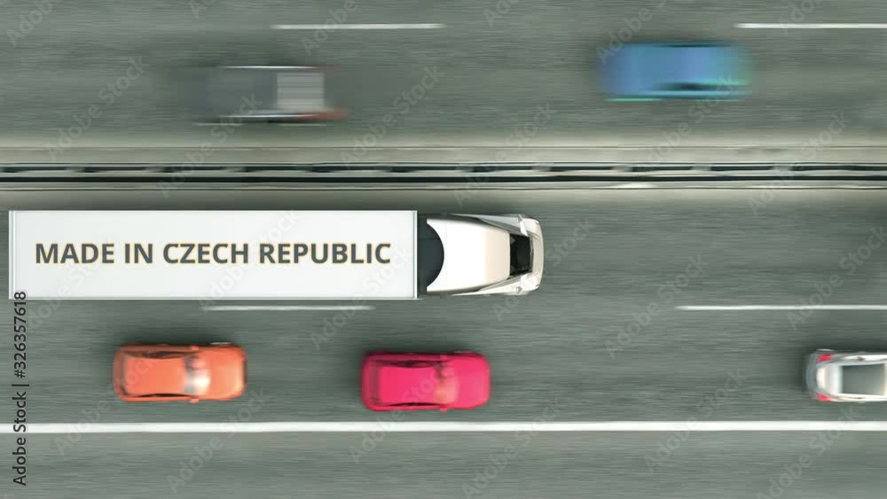 Aerial top down view of semi-trailer trucks with MADE IN CZECH REPUBLIC text driving along the road. business related loopable 3D animation Aerial top down view of semi-trailer trucks with MADE IN CZECH REPUBLIC text driving along the road. business related loopable 3D animation