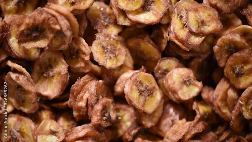 Dried banana on rotating background. Dried fruits background. Vegan, vegetarian diet. Healthy lifestyle. Fresh sweet bananas texture, organic food. Food ingredient background. Dried banana on rotating background. Dried fruits background. Vegan, vegetarian diet. Healthy lifestyle. Fresh sweet bananas texture, organic food. Food ingredient background.