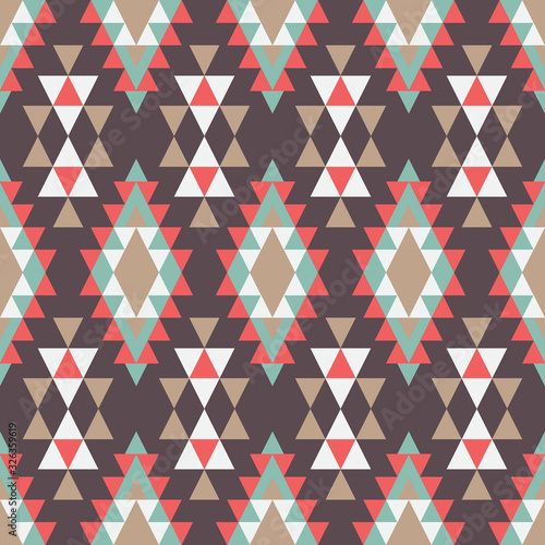 Geometric ornament of rhombuses and triangles in the native American style. Seamless vector pattern for web, print, textile, wallpaper, card, wrapping paper and background