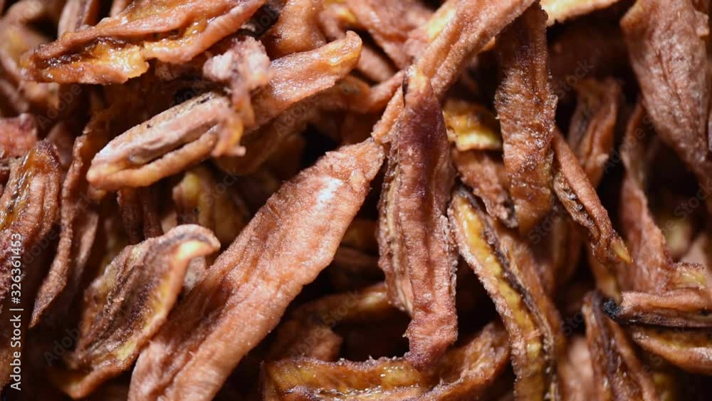 Dried banana on rotating background. Dried fruits background. Vegan, vegetarian diet. Healthy lifestyle. Fresh sweet bananas texture, organic food. Food ingredient background. Dried banana on rotating background. Dried fruits background. Vegan, vegetarian diet. Healthy lifestyle. Fresh sweet bananas texture, organic food. Food ingredient background.