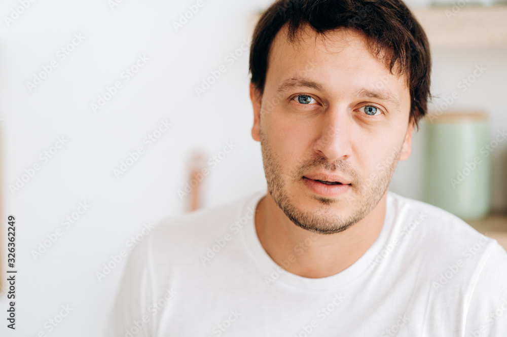 Portrait of a handsome blue-eyed guy in a white T-shirt Portrait of a handsome blue-eyed guy in a white T-shirt