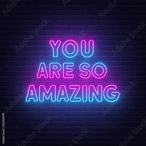 You are so amazing neon lettering. Neon sign on brick wall background.
