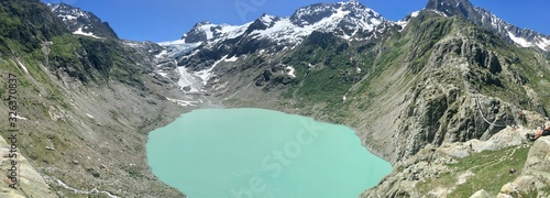 Panoramic view of the Trift Lake in central Switzerland during spring day