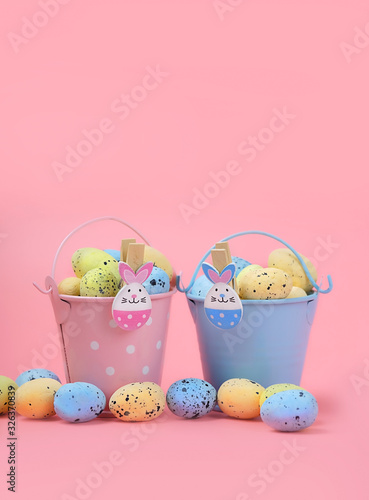 Happy Easter. bunny toy and egg in  bucket, on pink background. Easter holiday concept, spring season. minimal decor. copy space