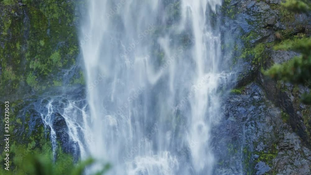 Devils Punchbowl Waterfall of Arthur's Pass in New Zealand; water splashing against rocks; waterfall falling down like silk threads Devils Punchbowl Waterfall of Arthur's Pass in New Zealand; water splashing against rocks; waterfall falling down like silk threads
