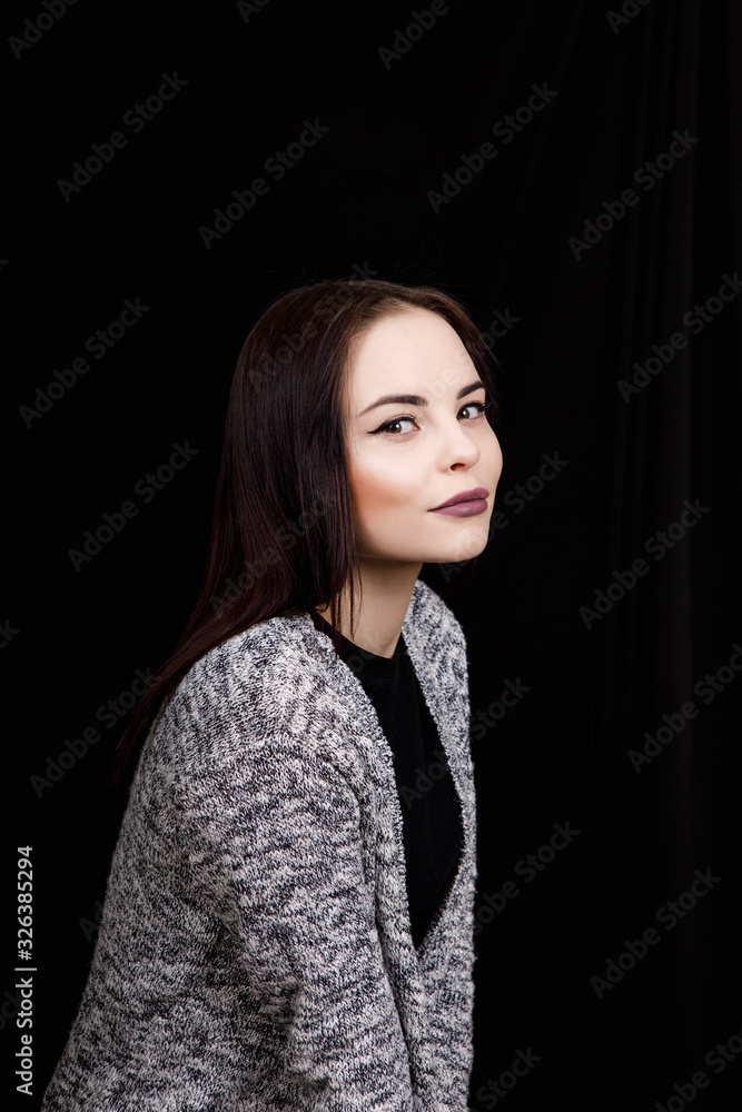 Cute girl dressed in casual wear is smiling on black background Cute girl dressed in casual wear is smiling on black background