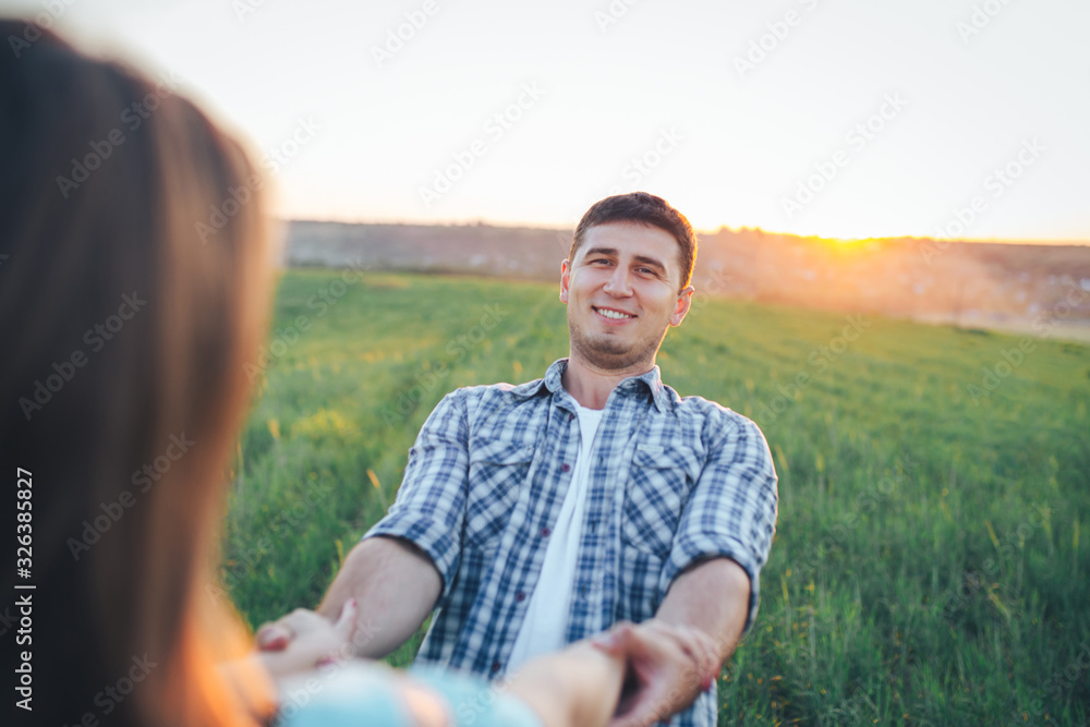 Fototapeta premium Guy with a girl spinning holding hands