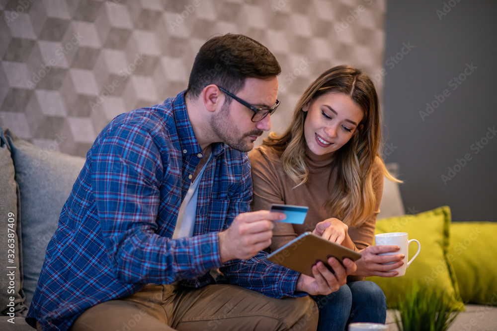 Smiling couple with tablet at home Smiling couple with tablet at home