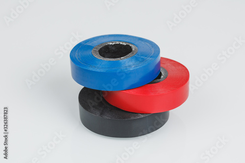 Adhesive insulating tapes or plastic duct tape rolls, gray background