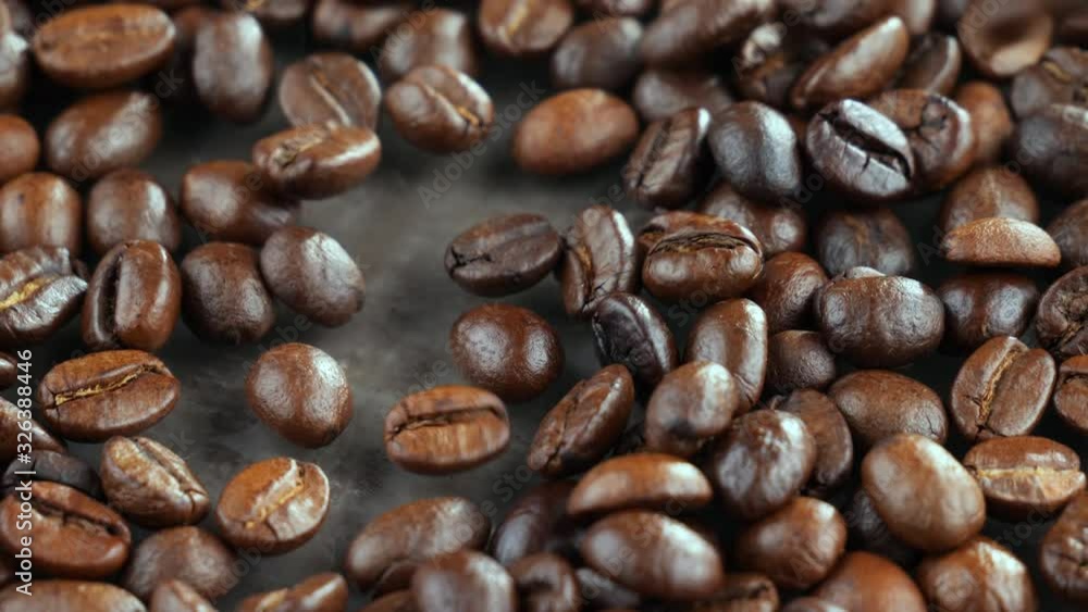 Coffee beans are fried in a pan and mixed with a spoon Coffee beans are fried in a pan and mixed with a spoon