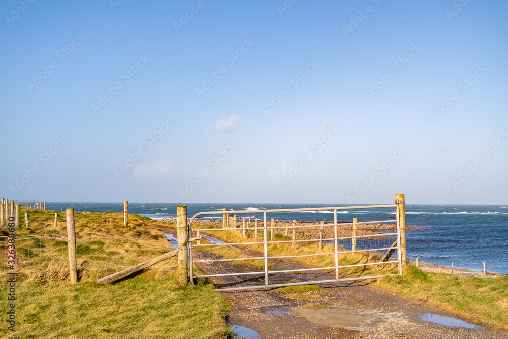 Gate next to beach at Fanad peninsula in County Donegal - Ireland