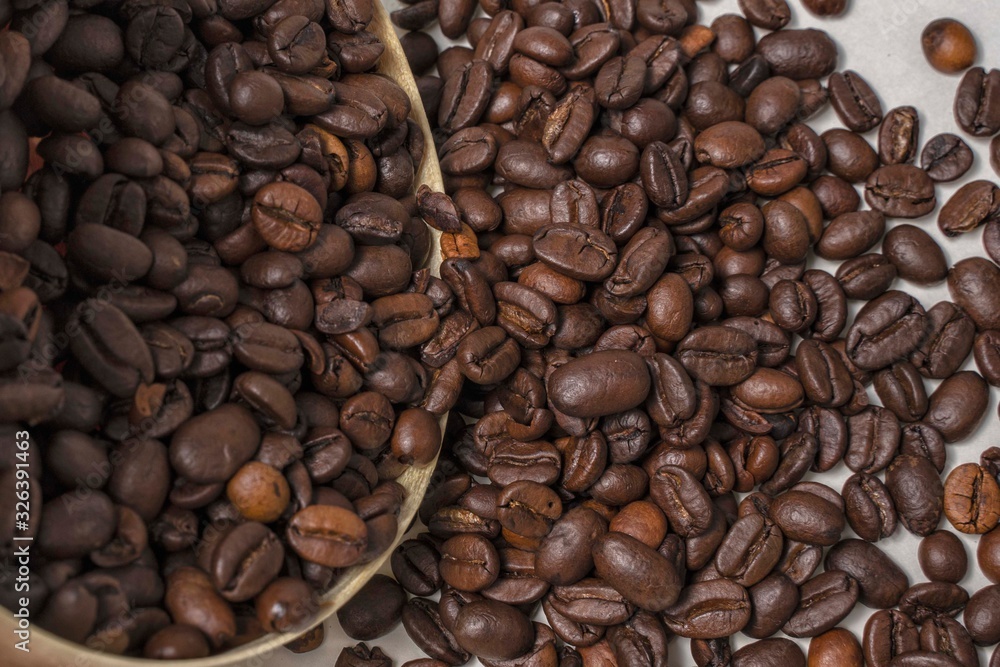 coffee beans spill out of a wooden container close-up coffee beans spill out of a wooden container close-up