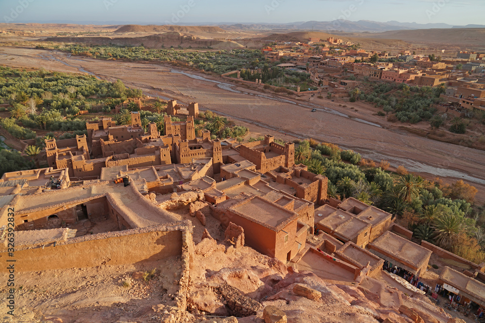 Ait Benhaddou panoramic aerial view of clay houses and valley with river before sunset, Morocco