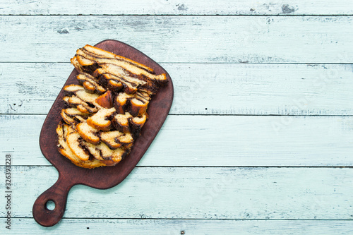 sliced babka, choclate challah dessert on old blue wooden table, top view