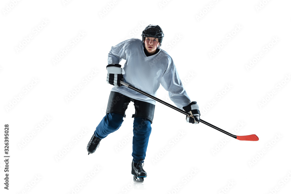 Running. Young male hockey player with the stick on ice court and white background. Sportsman wearing equipment and helmet practicing. Concept of sport, healthy lifestyle, motion, movement, action. Running. Young male hockey player with the stick on ice court and white background. Sportsman wearing equipment and helmet practicing. Concept of sport, healthy lifestyle, motion, movement, action.