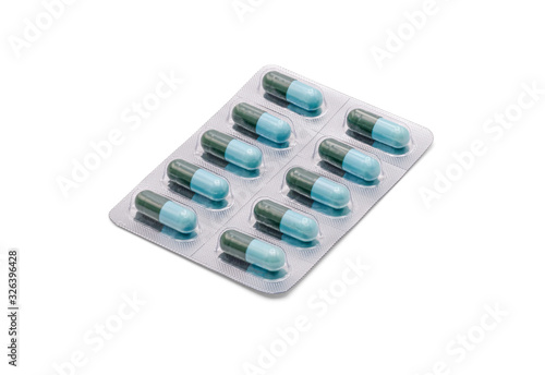 Close up on tablets and capsules pill in blister packaging arranged on white background, Pharmaceutical industry concept. Pharmacy drugstore, Amoxicillin capsule pills.