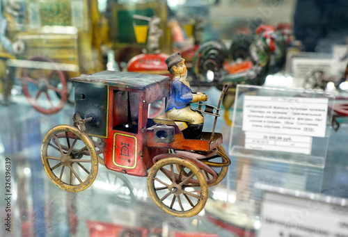  Metal locomotive. Vintage metal car. Showcase with old toys in a retro toy store.