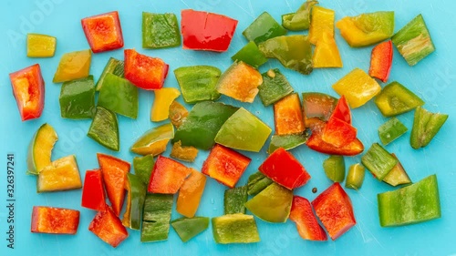 Pepper are freezes on blue background. Harvesting vegetables for the winter. Frozen vegetables close-up. Time lapse.  photo