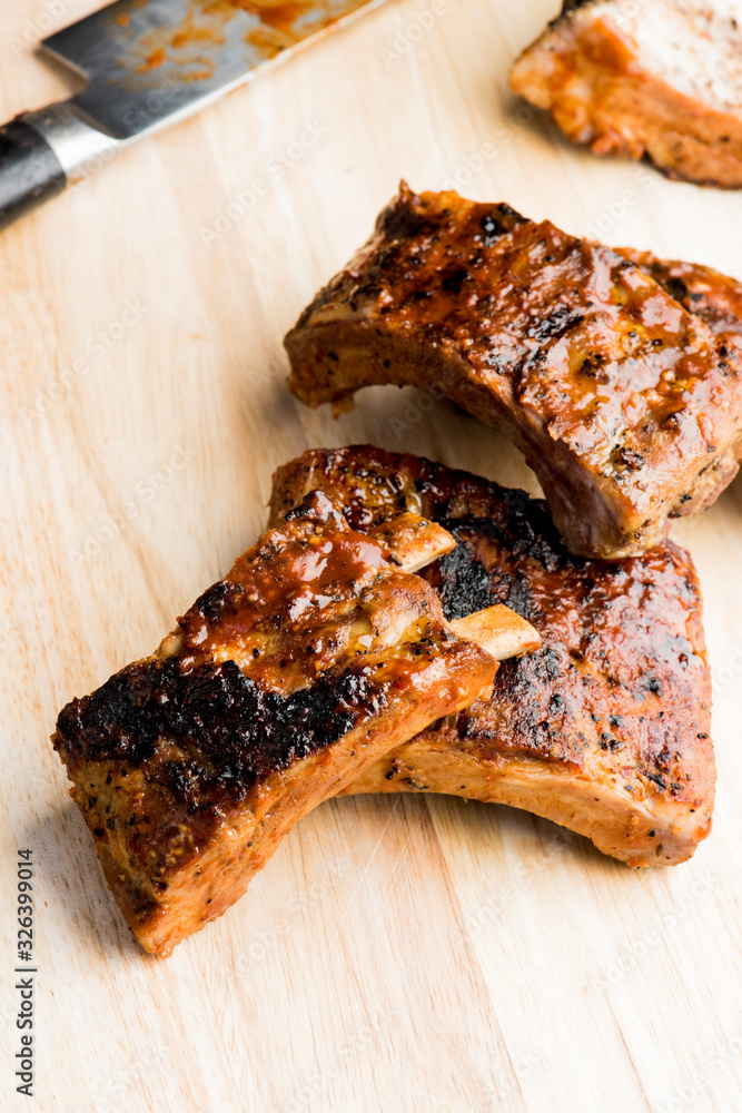 Pork BBQ Ribs. Traditional classic american barbecue staple. Pork ribs seasoned with a dry rub and slow smoked over mesquite wood chips served with homemade bbq sauce. Pork BBQ Ribs. Traditional classic american barbecue staple. Pork ribs seasoned with a dry rub and slow smoked over mesquite wood chips served with homemade bbq sauce.