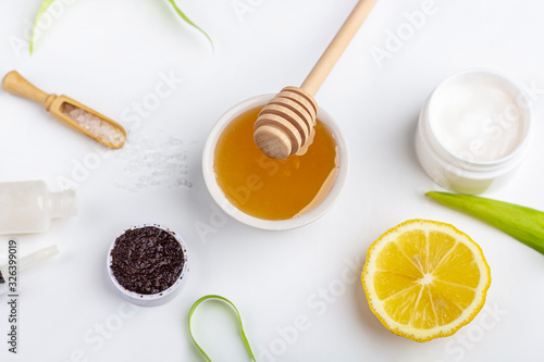 Wallpaper Mural Natural organic ingredients homemade skin care. Cleansing and nourishing cosmetic. Beauty products: cream, honey, coffee scrub,  among green leaves on white background. Close up, copy space for text Torontodigital.ca