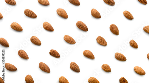 Almonds nuts isolated on white background. Flat lay pattern of roasted almond.