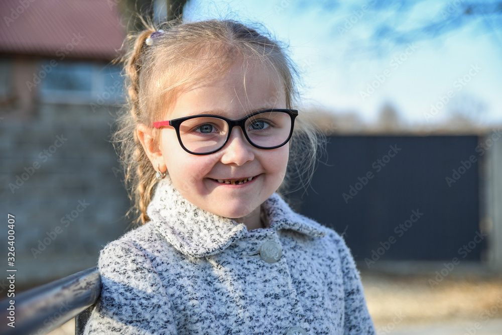 Portrait of a little, young cute smiling girl, close-up.Outdoor Portrait of a little, young cute smiling girl, close-up.Outdoor