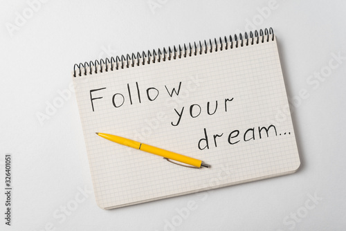 Wallpaper Mural Follow your dream motivation notice. Notepad and pen on white background. Torontodigital.ca