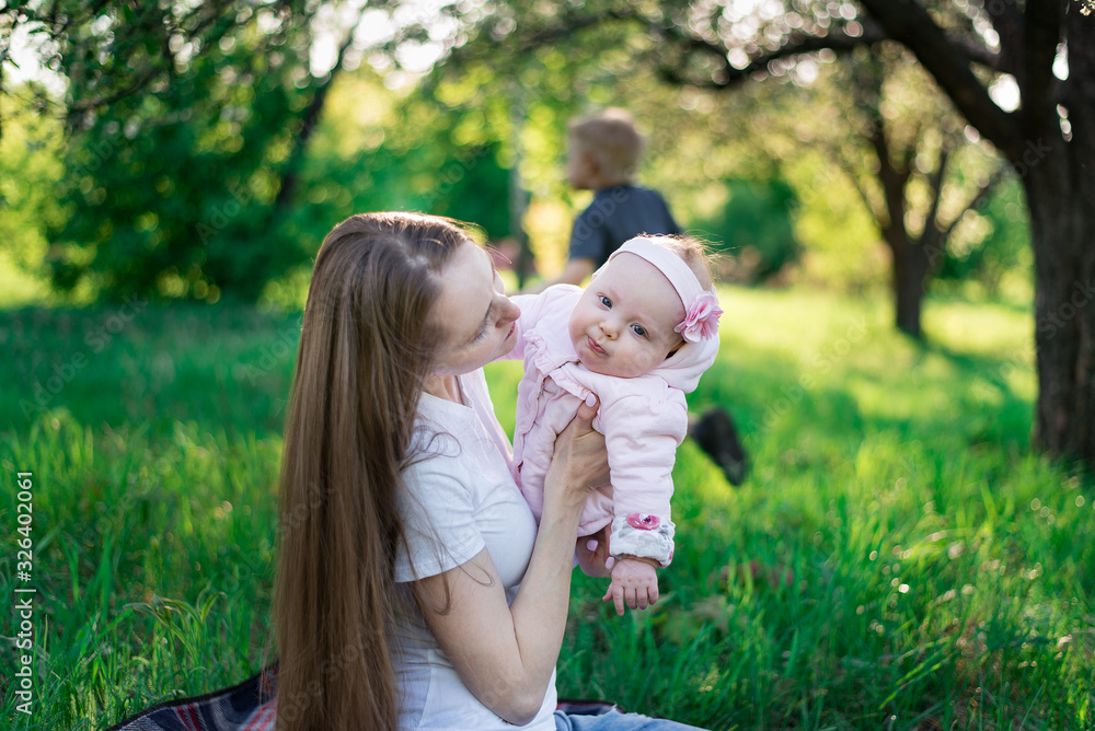 Young mother walking with small child in Park. Child and parenthood concept Young mother walking with small child in Park. Child and parenthood concept
