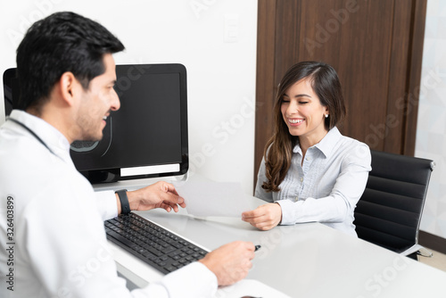 Smiling Woman Visiting Male Doctor