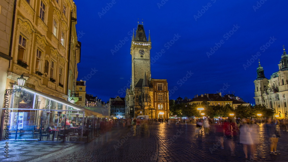 Prague Old Town Hall at Night timelapse  with unrecognizable tourists walking