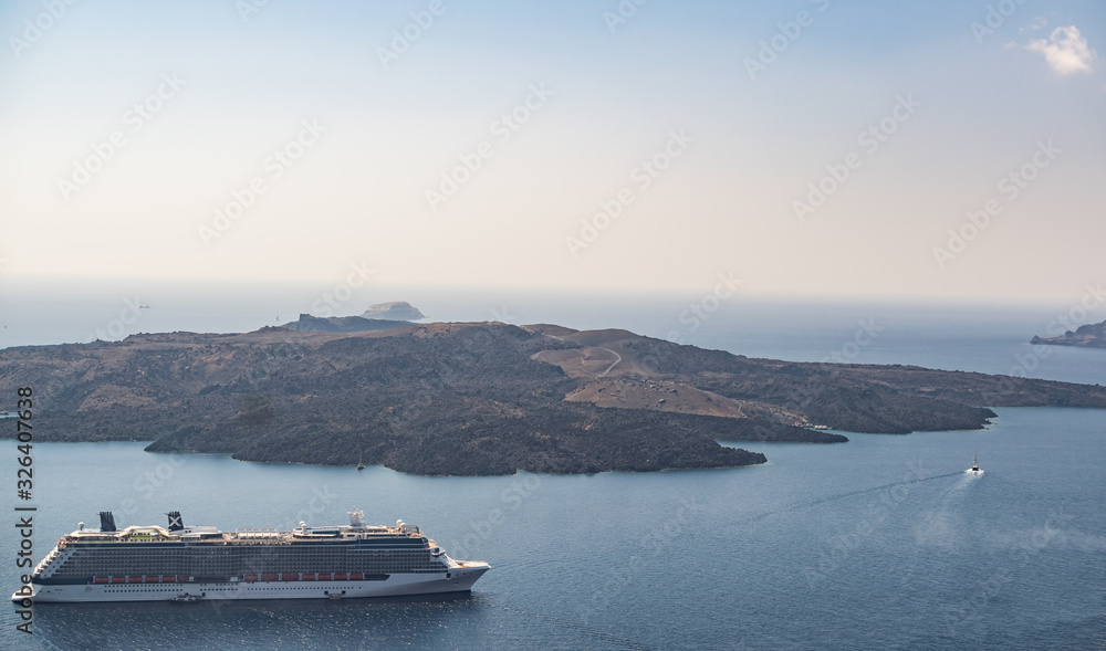 Cruise liner at the sea near the Greek Islands. Beautiful landscape with sea view. Santorini island, Greece